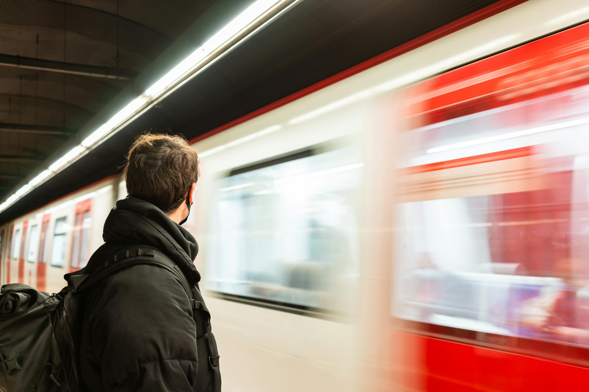 unrecognizable man near moving train